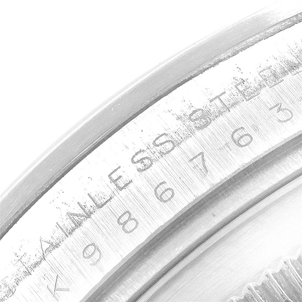 The image shows a close-up of the edge and part of the case back of a Rolex Explorer 114270 Men's Stainless Steel Black Dial 114270 Men's Stainless Steel Black Dial watch, highlighting the "STAINLESS STEEL" engraving.
