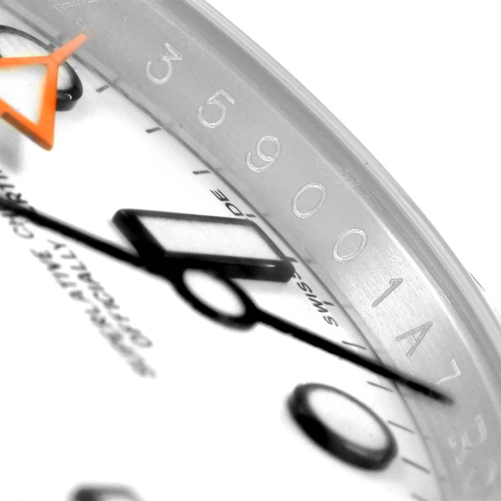 This close-up image of a Rolex Explorer 216570 Men's Stainless Steel White Dial 216570 Men's Stainless Steel White Dial watch shows part of the dial, hour markers, and hands at an angle.