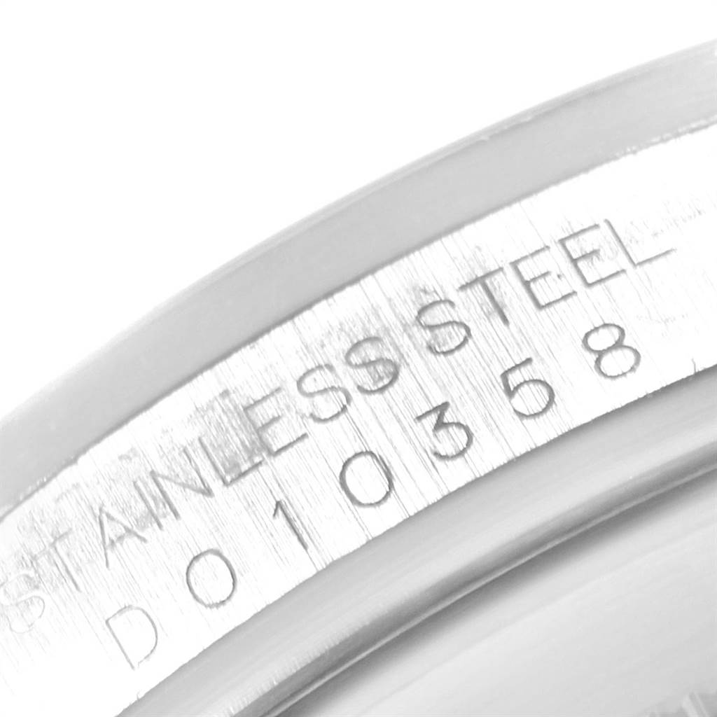 This close-up image shows the engraved serial number and "Stainless Steel" marking on the bezel of a Rolex Explorer 16570 Men's Stainless Steel White Dial 16570 Men's Stainless Steel White Dial watch.