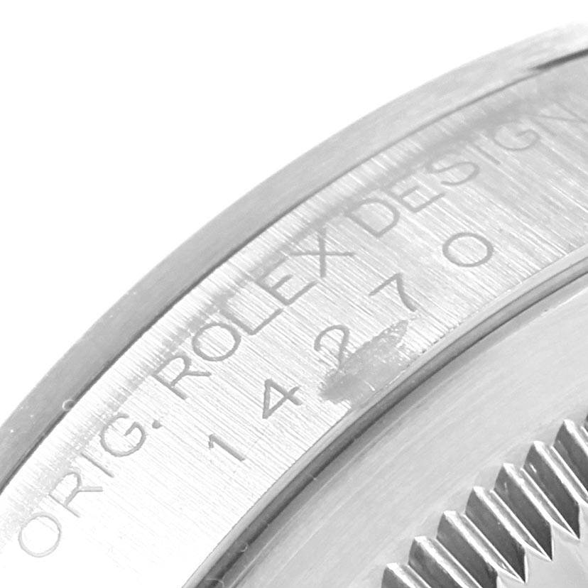 This image shows a close-up of the serial number and part of the case back of a Rolex Explorer 14270 Men's Stainless Steel Black Dial 14270 Men's Stainless Steel Black Dial watch.