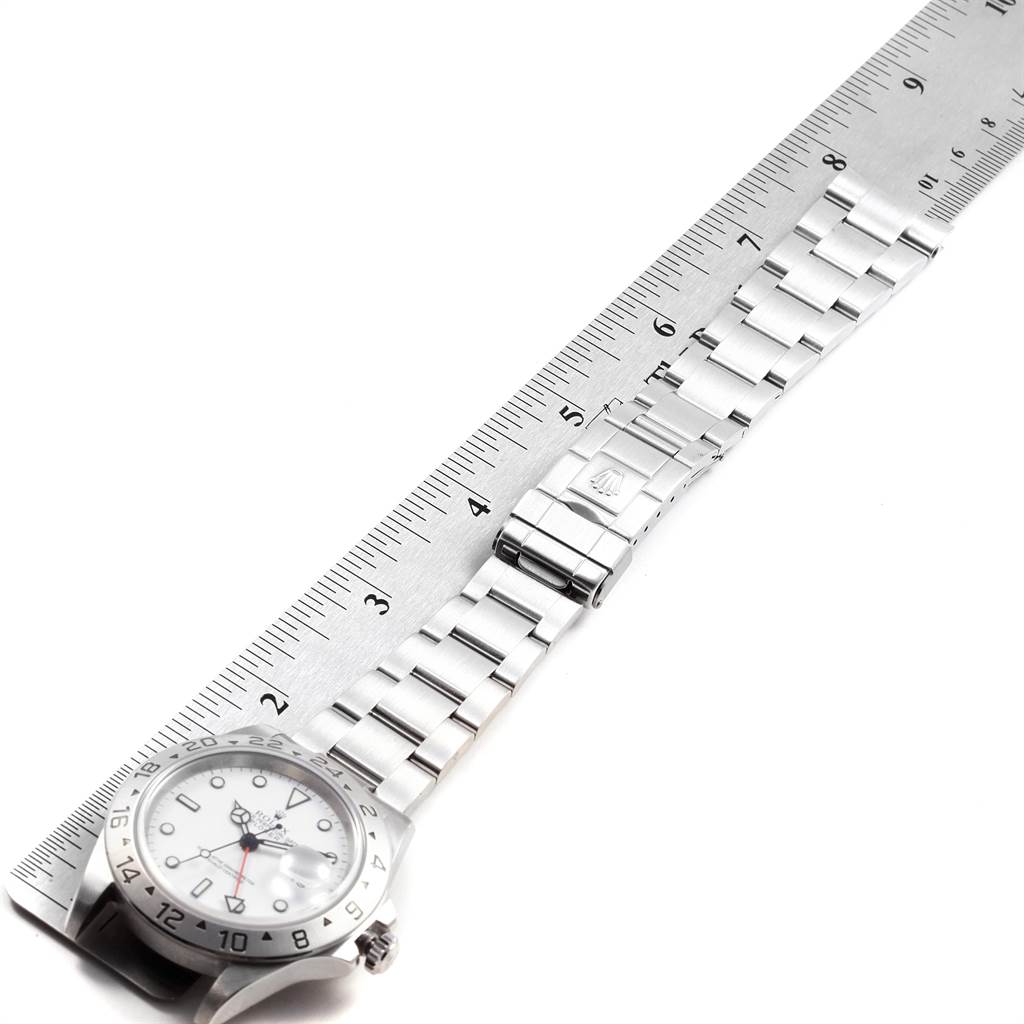 The image shows a Rolex Explorer 16570 Men's Stainless Steel White Dial 16570 Men's Stainless Steel White Dial watch laid flat, with the dial partially visible and the bracelet fully extended along a ruler.