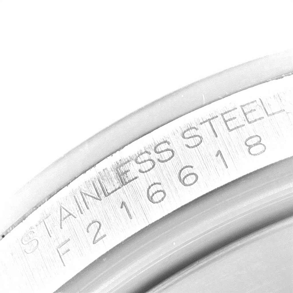 This close-up image shows the serial number engraving on the stainless steel case of a Rolex Explorer 16570 Men's Stainless Steel White Dial 16570 Men's Stainless Steel White Dial watch.