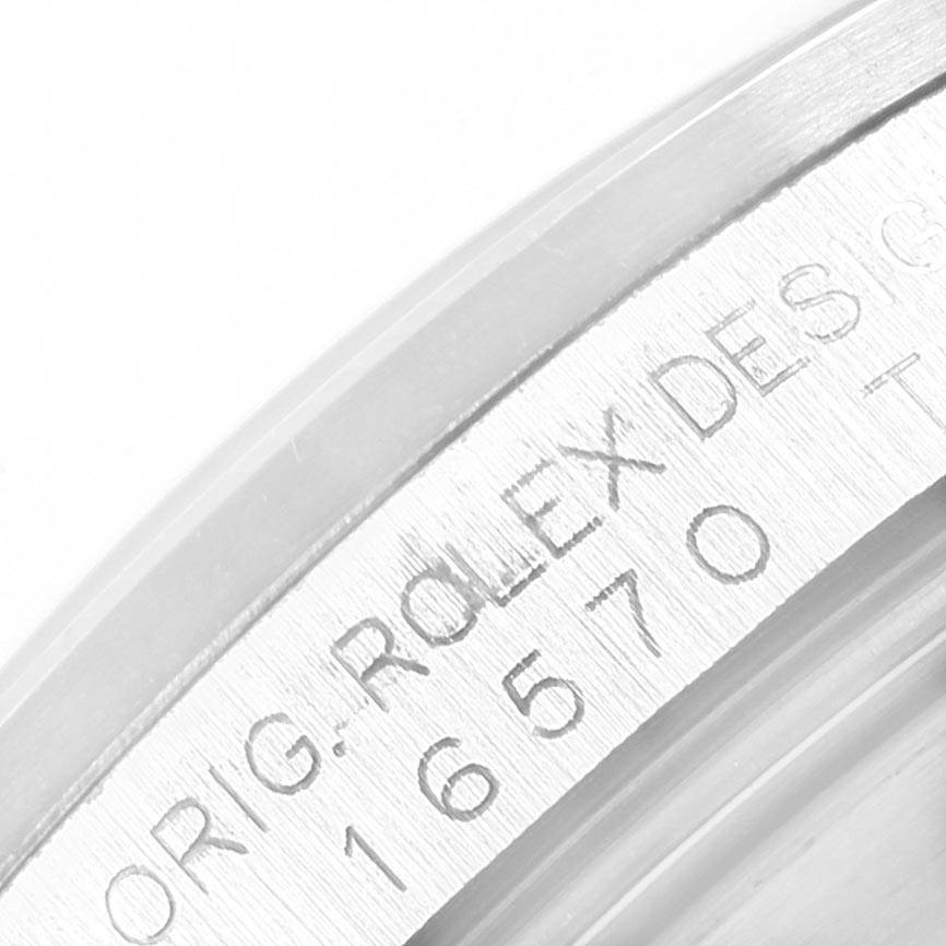 The image shows a close-up of the side engraving on a Rolex Explorer 16570 Men's Stainless Steel White Dial 16570 Men's Stainless Steel White Dial watch case.