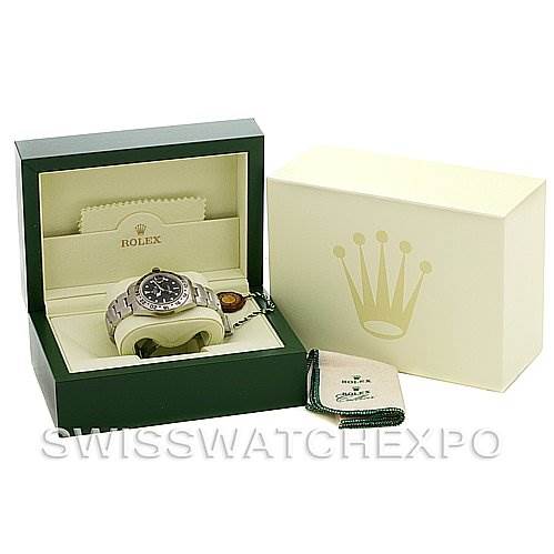 This image shows a Rolex Explorer 16570 Men's Stainless Steel Black Dial 16570 Men's Stainless Steel Black Dial watch in its open box with a cleaning cloth and an outer box, viewed from the front.