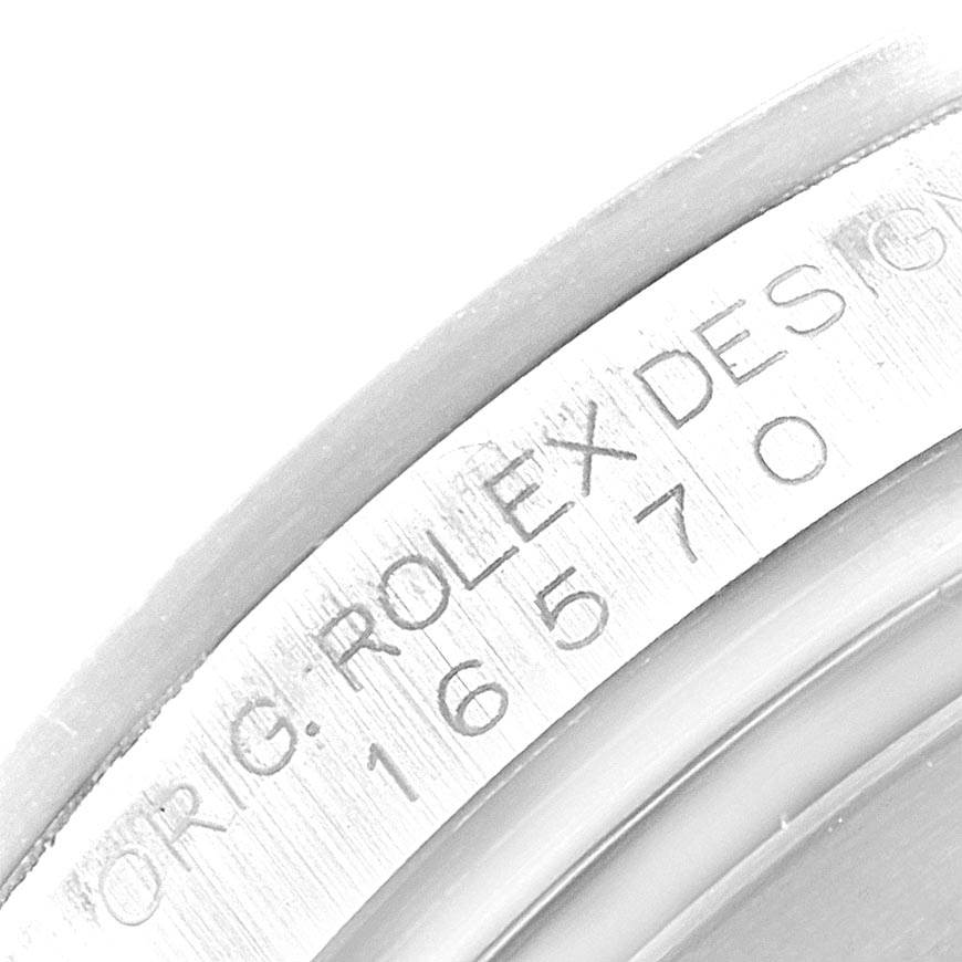 This close-up image shows the serial and model number engravings on the case of a Rolex Explorer 16570 Men's Stainless Steel White Dial 16570 Men's Stainless Steel White Dial watch.