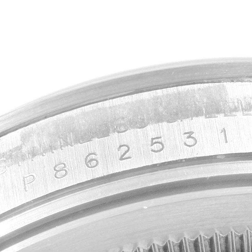 The image shows a close-up view of the serial number engraving on the casing of a Rolex Explorer 114270 Men's Stainless Steel Black Dial 114270 Men's Stainless Steel Black Dial watch.