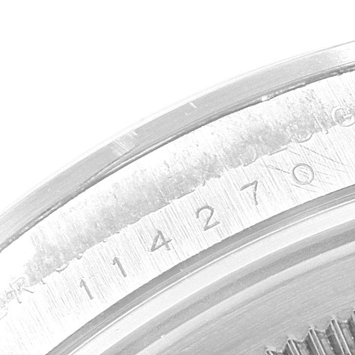 The image shows a close-up of the inner bezel with engravings of a Rolex Explorer 114270 Men's Stainless Steel Black Dial 114270 Men's Stainless Steel Black Dial model watch.