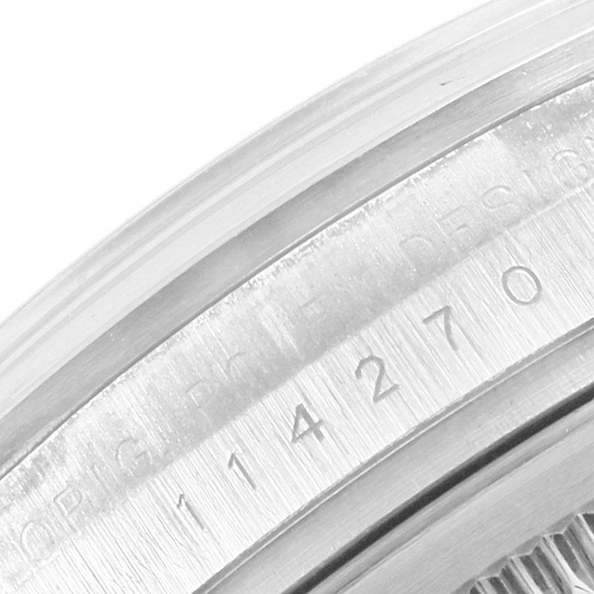This close-up image shows the engraved serial number on the inner bezel of the Rolex Explorer 114270 Men's Stainless Steel Black Dial 114270 Men's Stainless Steel Black Dial watch.