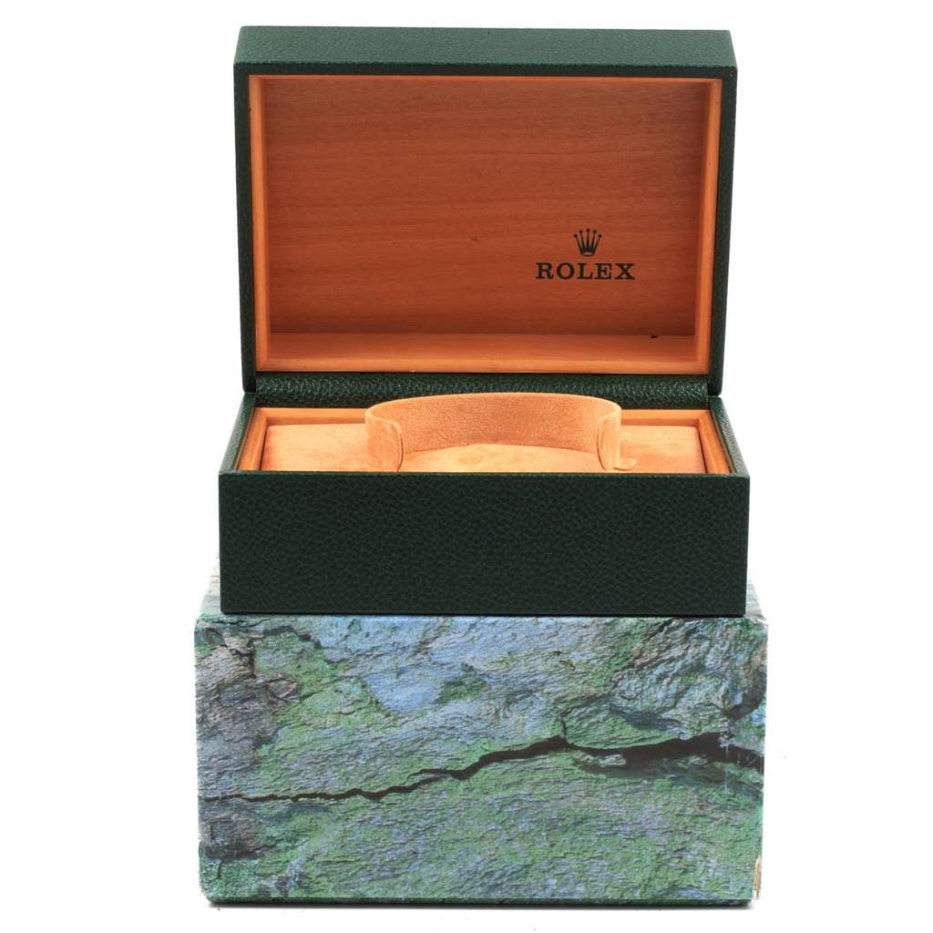 The image shows an open Rolex Explorer 114270 Men's Stainless Steel Black Dial 114270 Men's Stainless Steel Black Dial watch box with an interior cushion and wooden lining.