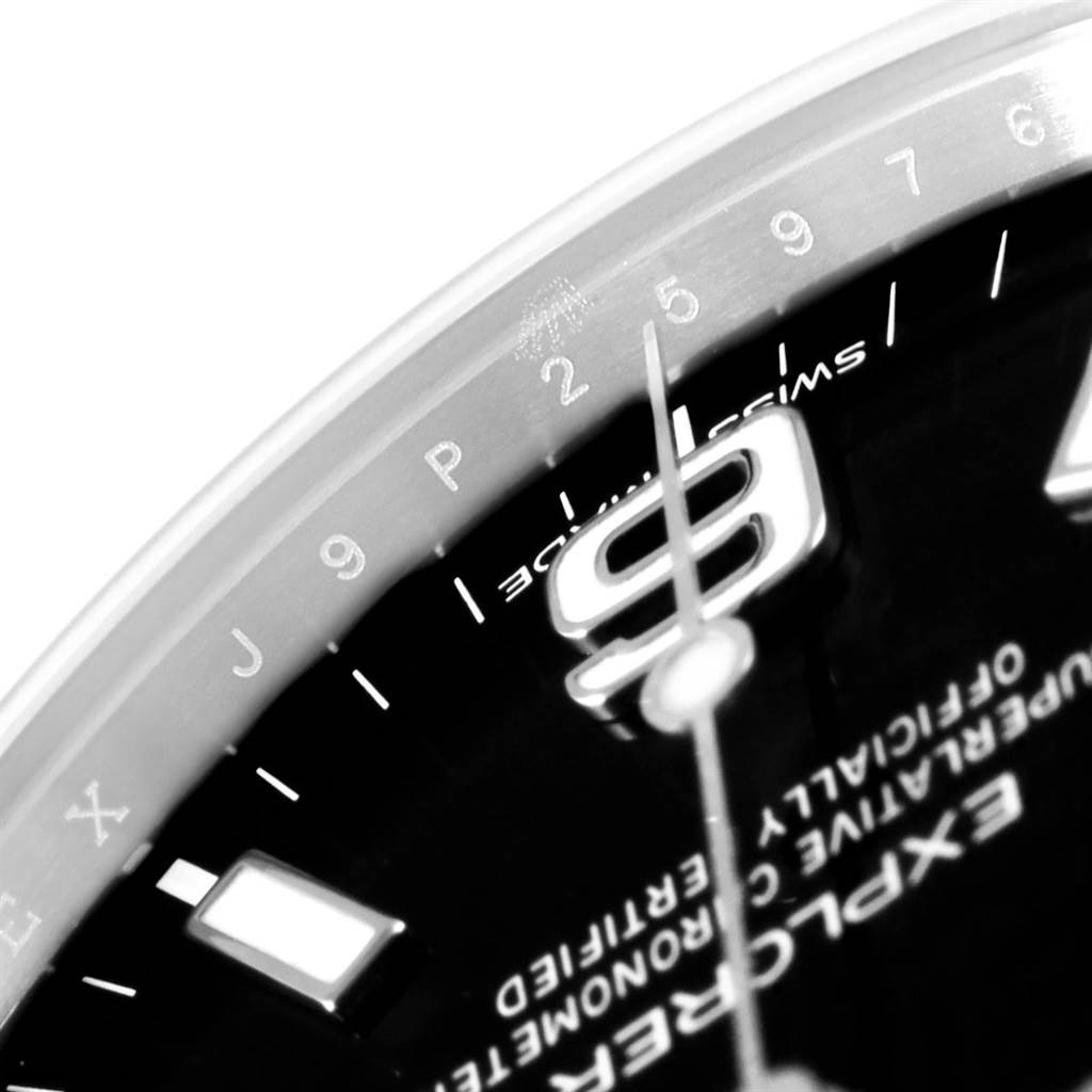 This close-up image shows a partial view of the dial of a Rolex Explorer 214270 Men's Stainless Steel Black Dial 214270 Men's Stainless Steel Black Dial watch, featuring the number 9 and Swiss made text.