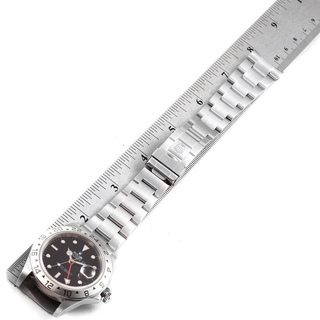 The image shows a Rolex Explorer 16570 Men's Stainless Steel Black Dial 16570 Men's Stainless Steel Black Dial watch face and bracelet laid flat and aligned with a ruler for measurement.