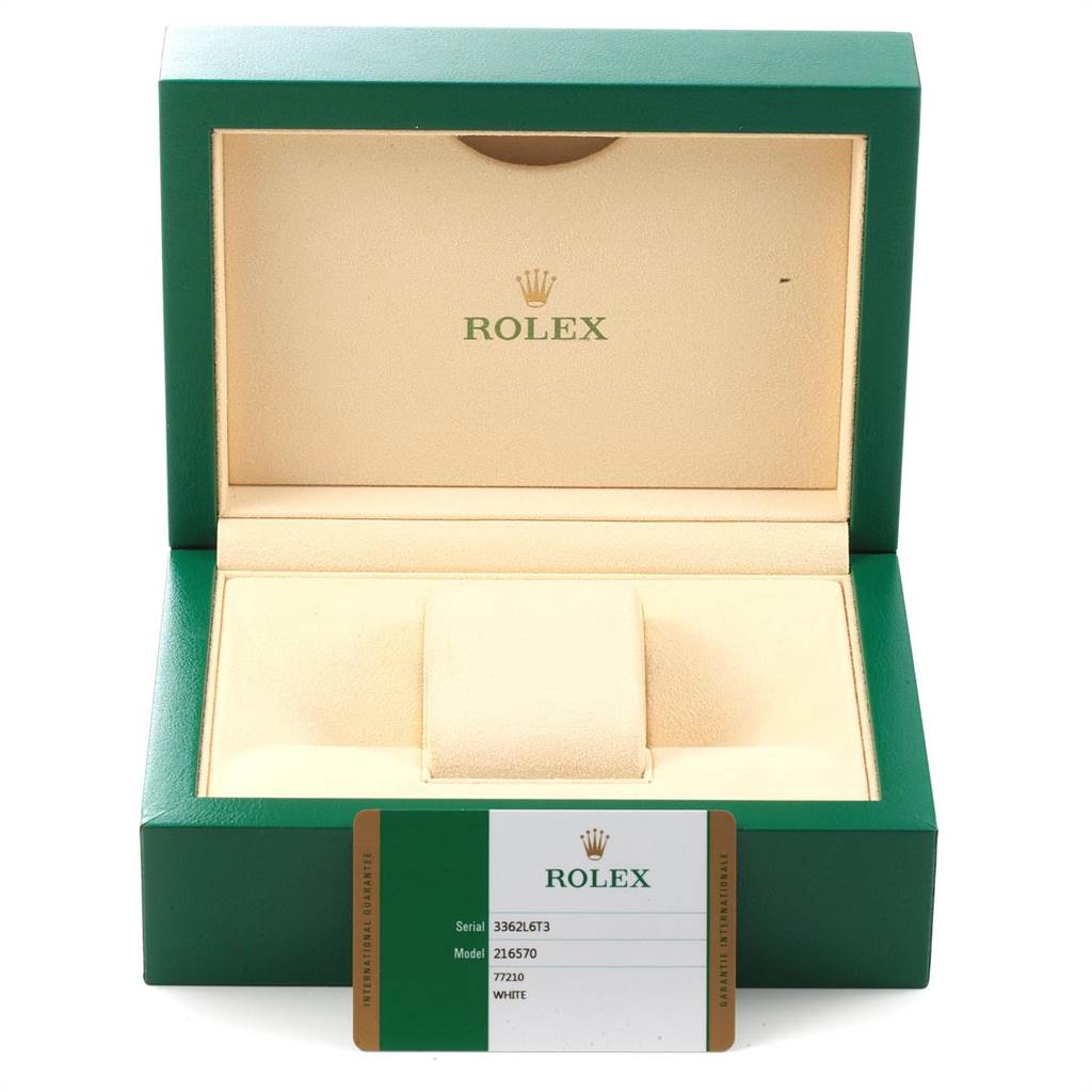This image shows a green Rolex box for the Explorer model, with an international guarantee card displayed in front.