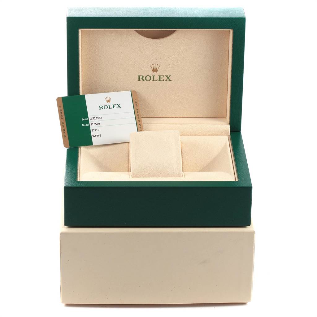 The image depicts an open Rolex watch box for an Explorer model, along with the warranty card placed inside.