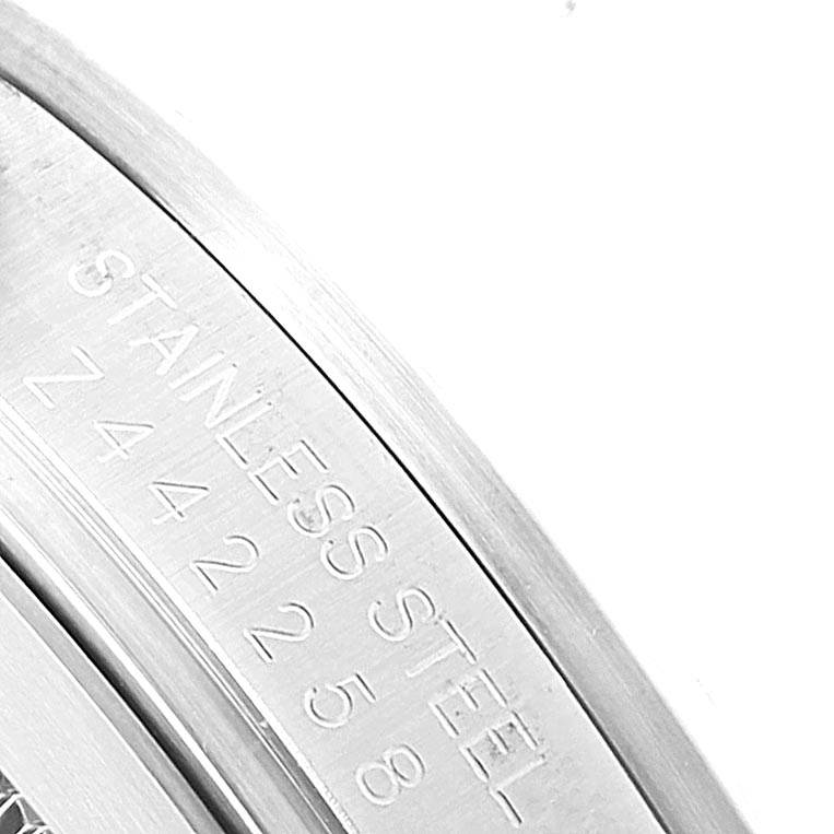 This image shows a close-up angle of the case side of a Rolex Explorer 16570 Men's Stainless Steel White Dial 16570 Men's Stainless Steel White Dial, revealing the engraved serial number and "STAINLESS STEEL" text.