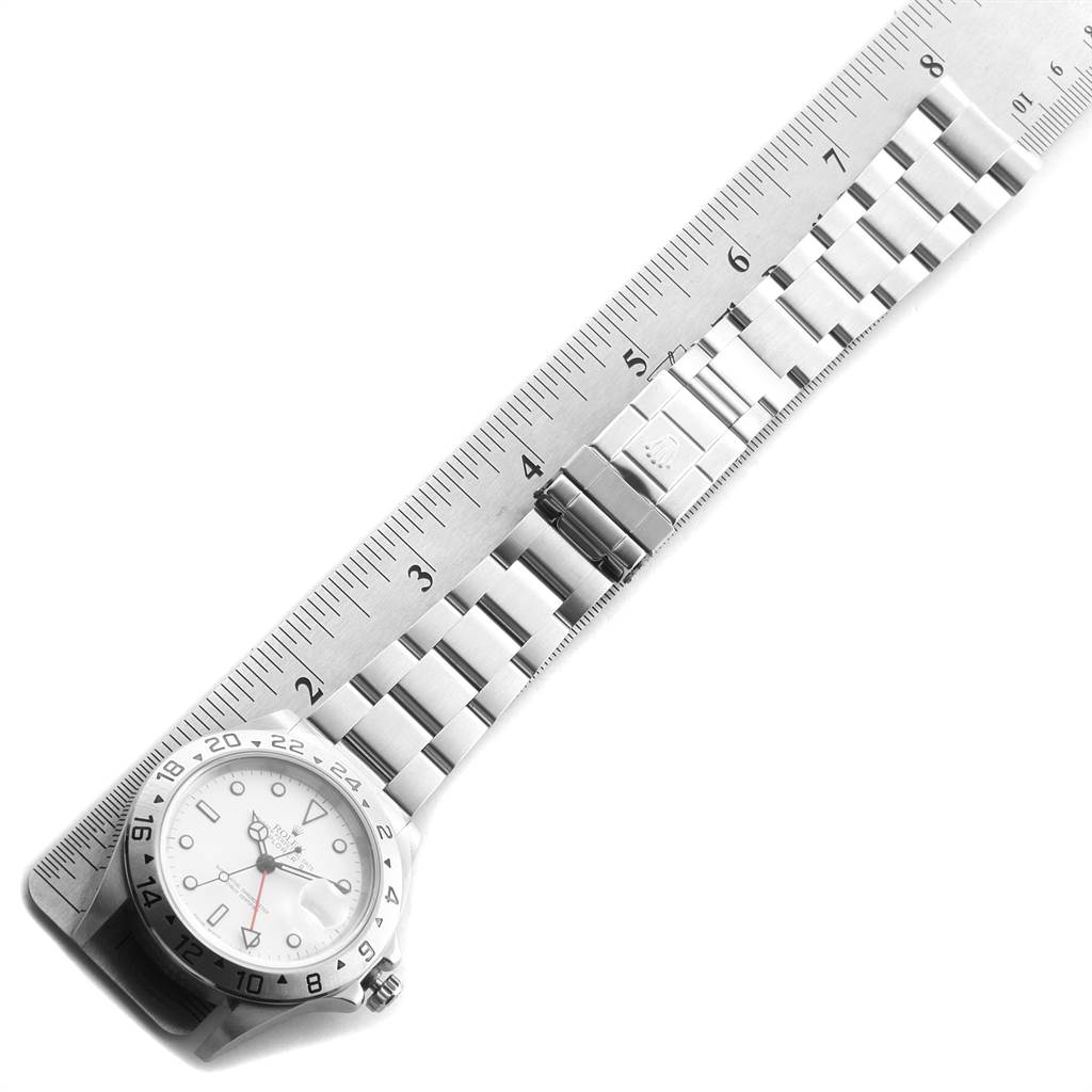 The image shows a Rolex Explorer 16570 Men's Stainless Steel White Dial 16570 Men's Stainless Steel White Dial model watch placed next to a ruler, displaying the bracelet and partially the watch face.