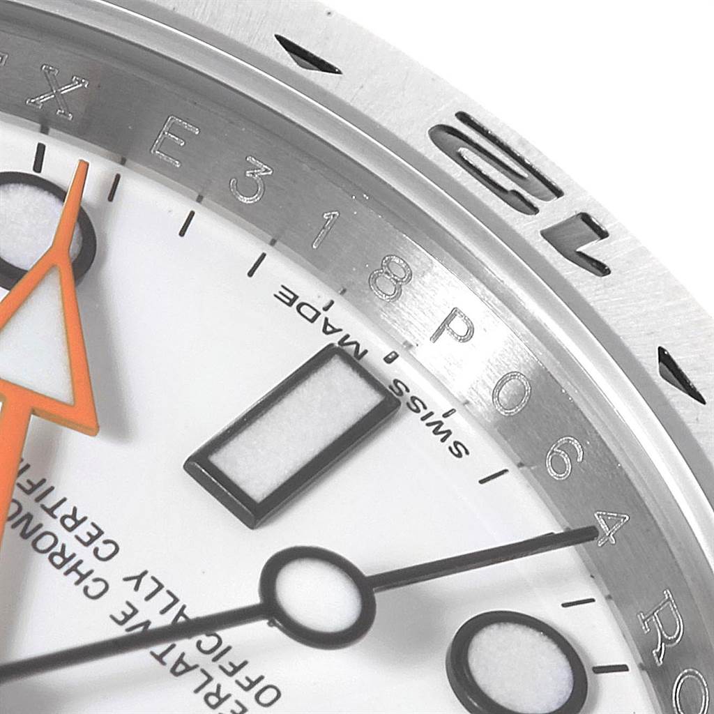 Close-up of the Rolex Explorer 216570 Men's Stainless Steel White Dial 216570 Men's Stainless Steel White Dial watch face, showing the bezel, hands, and part of the dial.