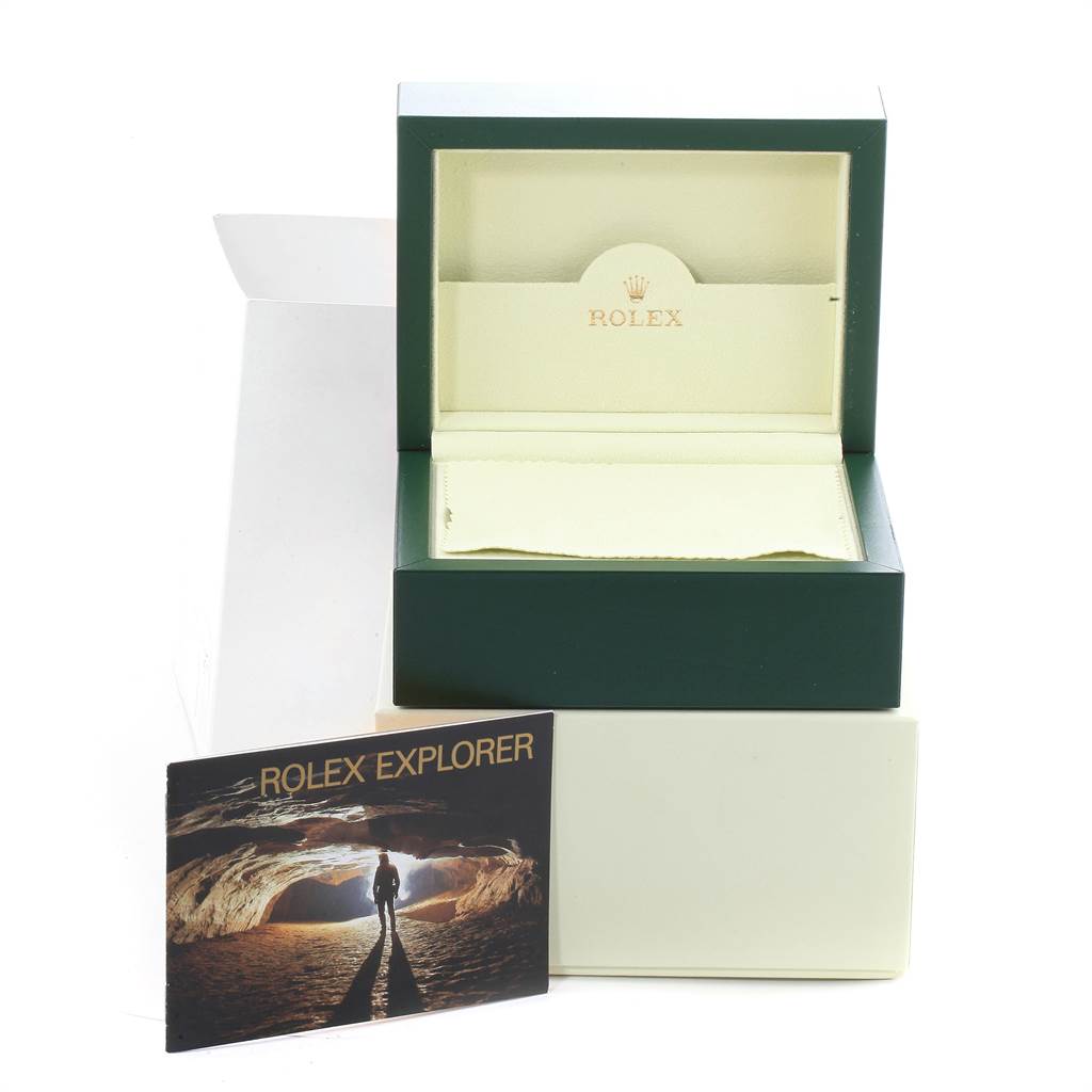 The image shows the opened box and accompanying booklet for the Rolex Explorer 16570 Men's Stainless Steel White Dial 16570 Men's Stainless Steel White Dial model watch from a front angle.
