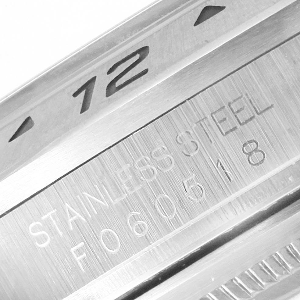 This image shows a close-up of the Rolex Explorer 16570 Men's Stainless Steel White Dial 16570 Men's Stainless Steel White Dial model, highlighting the stainless steel case with model and serial number engravings.