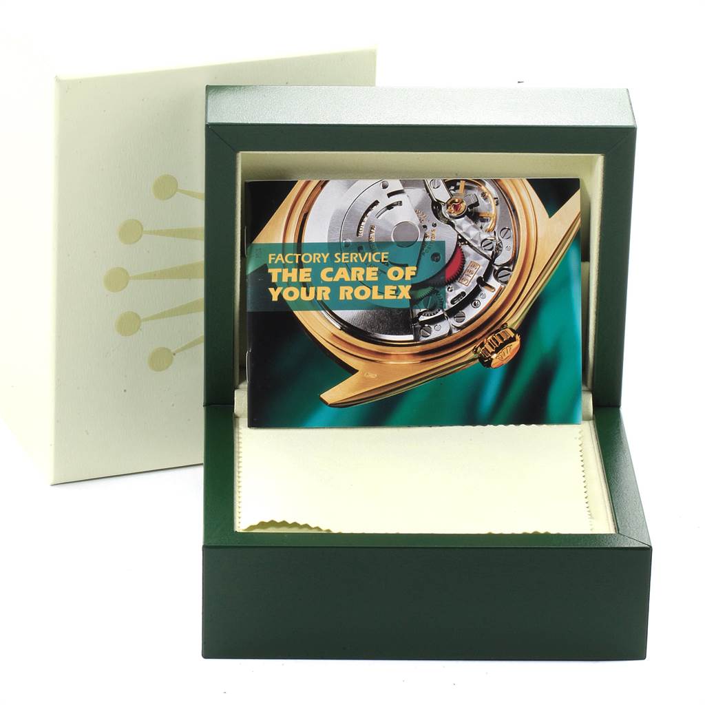 The image shows an angled view of the packaging box and the factory service manual of a Rolex Explorer 16570 Men
s Stainless Steel White Dial 16570 Men
s Stainless Steel White Dial watch.