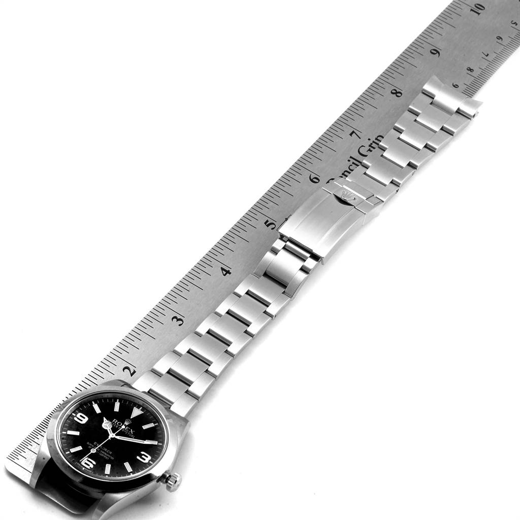 The image shows a top view of a Rolex Explorer 214270 Men's Stainless Steel Black Dial 214270 Men's Stainless Steel Black Dial watch including its dial, bracelet, and clasp.
