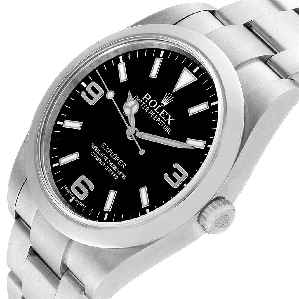 The image shows a Rolex Explorer 214270 Men
s Stainless Steel Black Dial 214270 Men
s Stainless Steel Black Dial watch at an angled close-up, highlighting the black dial, crown, and stainless steel bracelet.