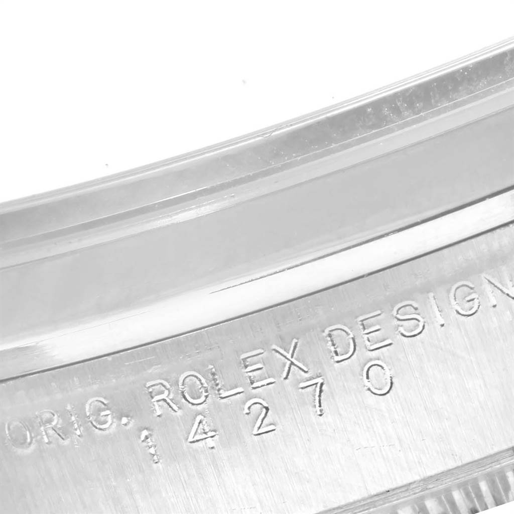 The image shows a close-up of the engraved serial number and "ORIG. ROLEX DESIGN" on the side of a Rolex Explorer 14270 Men's Stainless Steel Black Dial 14270 Men's Stainless Steel Black Dial model watch.