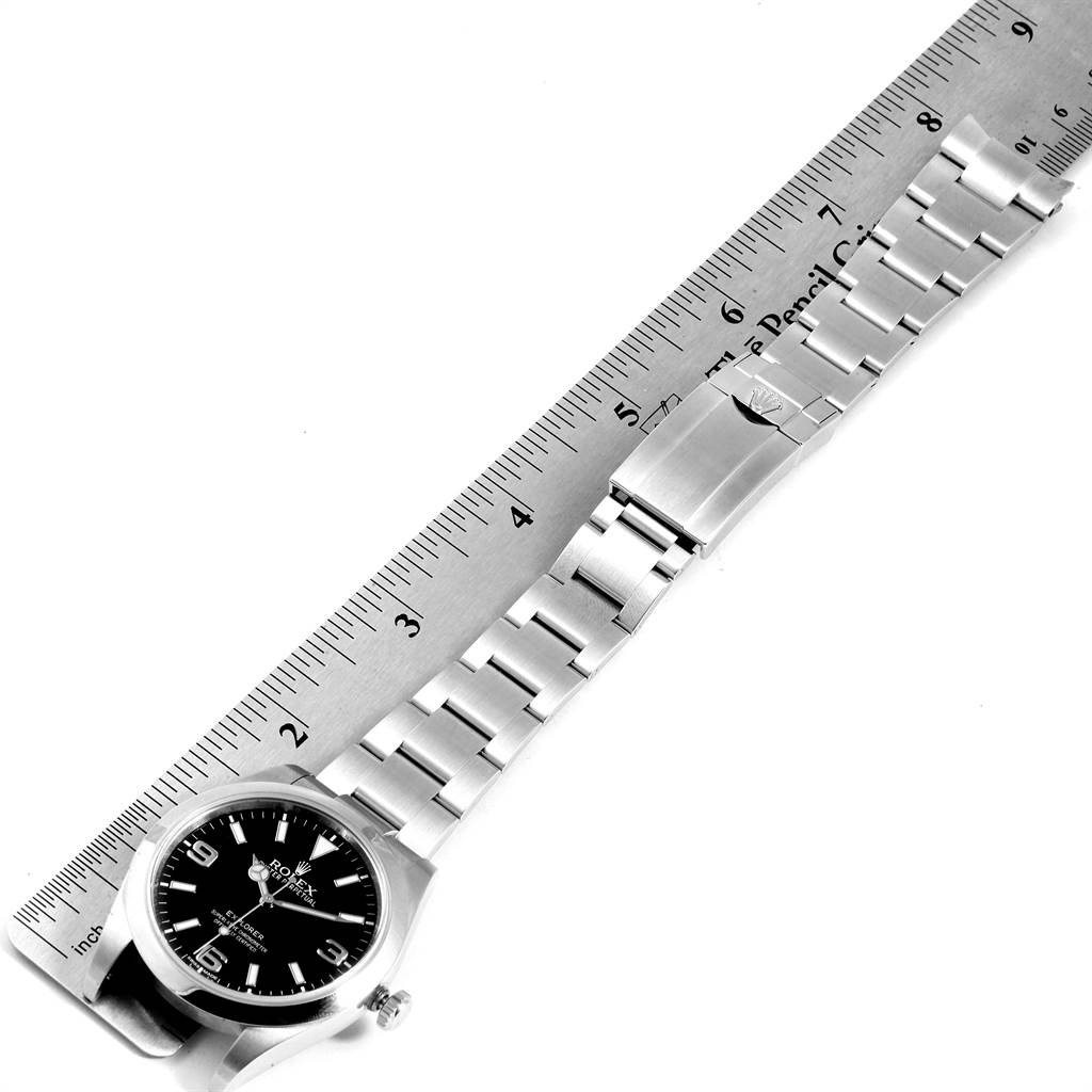 The image shows a Rolex Explorer 214270 Men's Stainless Steel Black Dial 214270 Men's Stainless Steel Black Dial watch, including the face, bracelet, and clasp, measured against a ruler.