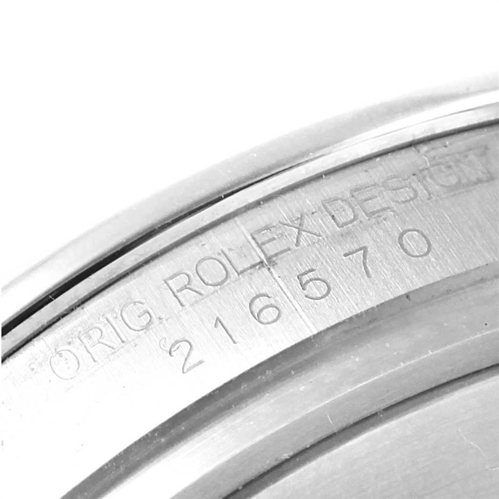 This image shows a close-up of the serial number and "ORIG. ROLEX DESIGN" engraving on the inner bezel of a Rolex Explorer 216570 Men's Stainless Steel Black Dial 216570 Men's Stainless Steel Black Dial.