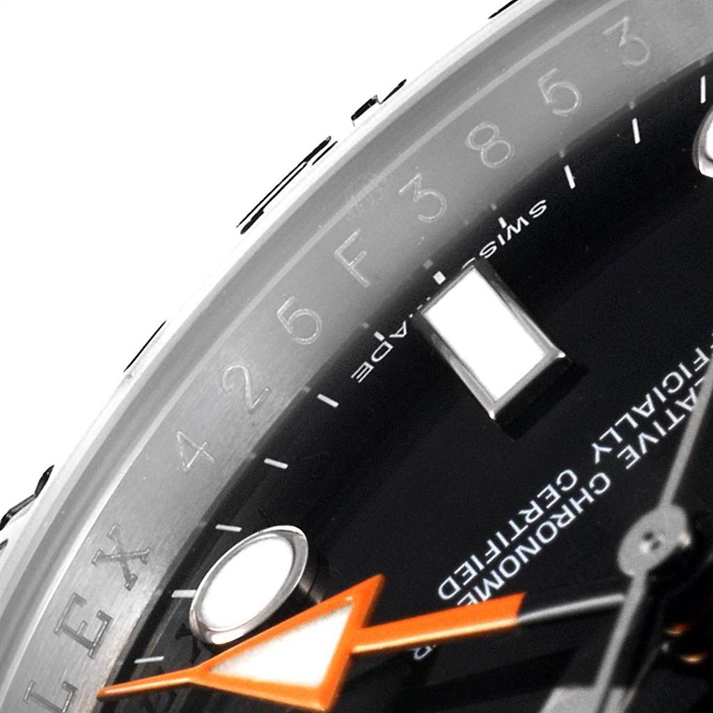This image shows a close-up of the dial, bezel, and orange hand of a Rolex Explorer 216570 Men's Stainless Steel Black Dial 216570 Men's Stainless Steel Black Dial watch, highlighting details and text.