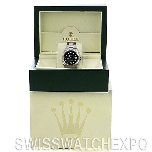 The image shows a Rolex Explorer 114270 Men
s Stainless Steel Black Dial 114270 Men
s Stainless Steel Black Dial watch from a front angle, displayed in its open green and cream box.
