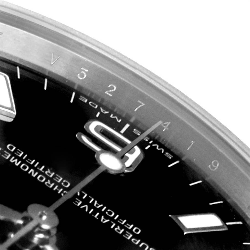 This close-up of a Rolex Explorer 114270 Men's Stainless Steel Black Dial 114270 Men's Stainless Steel Black Dial watch shows part of the dial, including the hour hand, minute markers, and "SWISS MADE" text.