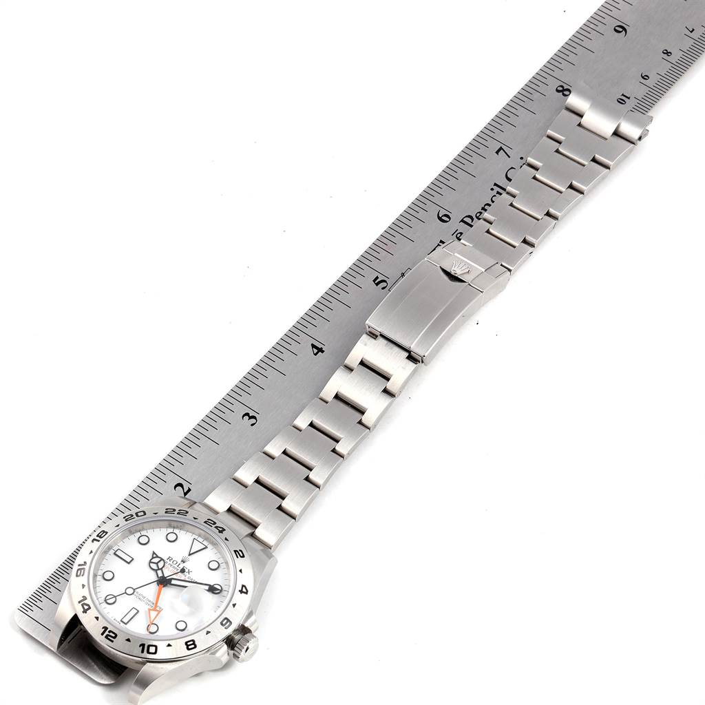 The image shows a Rolex Explorer 216570 Men's Stainless Steel White Dial 216570 Men's Stainless Steel White Dial watch, with a focus on the face and stainless steel band, beside a ruler for size reference.