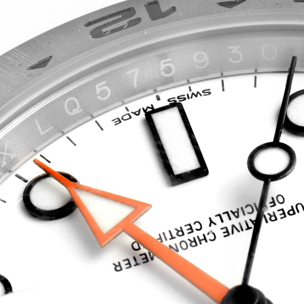 This close-up image of a Rolex Explorer 216570 Men's Stainless Steel White Dial 216570 Men's Stainless Steel White Dial watch shows the edge of the dial, the hands, and partial chapter ring.
