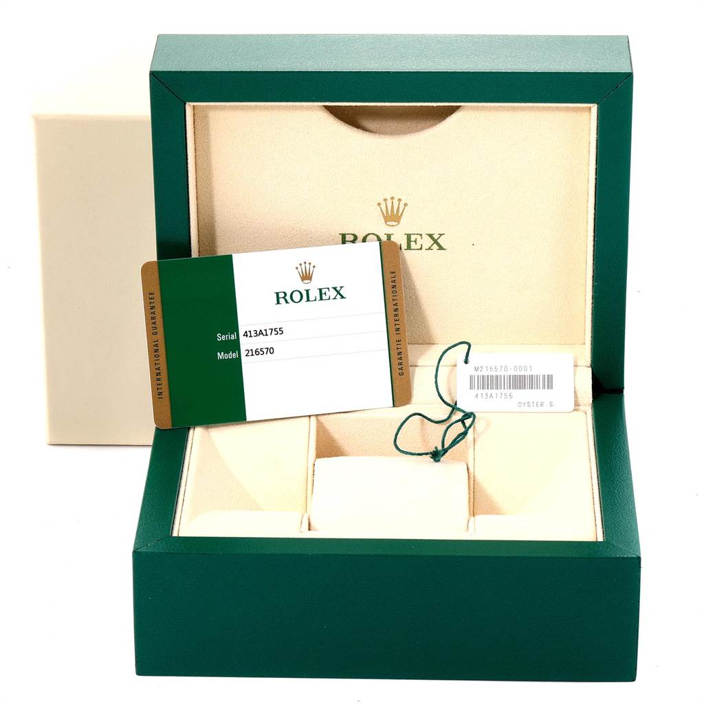 The image shows a green Rolex box containing an Explorer model international guarantee card and tags.
