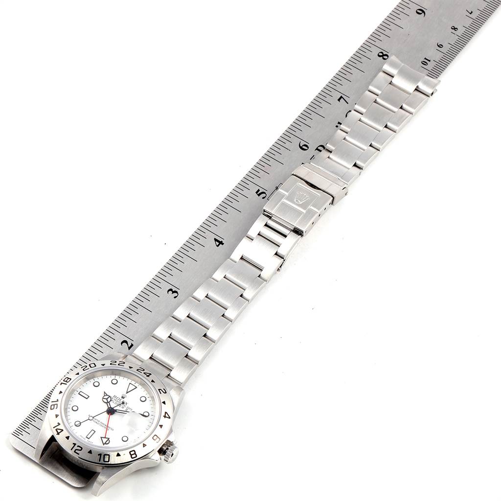 The image shows the Rolex Explorer 16570 Men's Stainless Steel White Dial 16570 Men's Stainless Steel White Dial watch laid flat with the dial, bracelet, and clasp visible alongside a ruler.