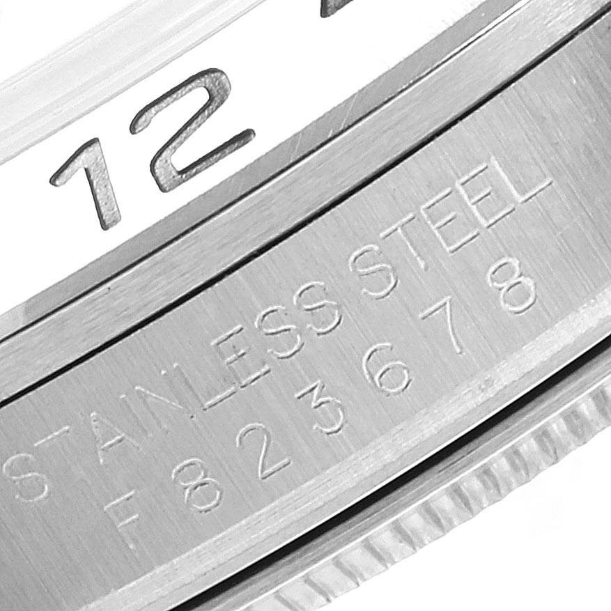 This image shows a close-up of the dial and case edge of a Rolex Explorer 16570 Men's Stainless Steel White Dial 16570 Men's Stainless Steel White Dial watch, highlighting the number "12" and "STAINLESS STEEL" engraving.