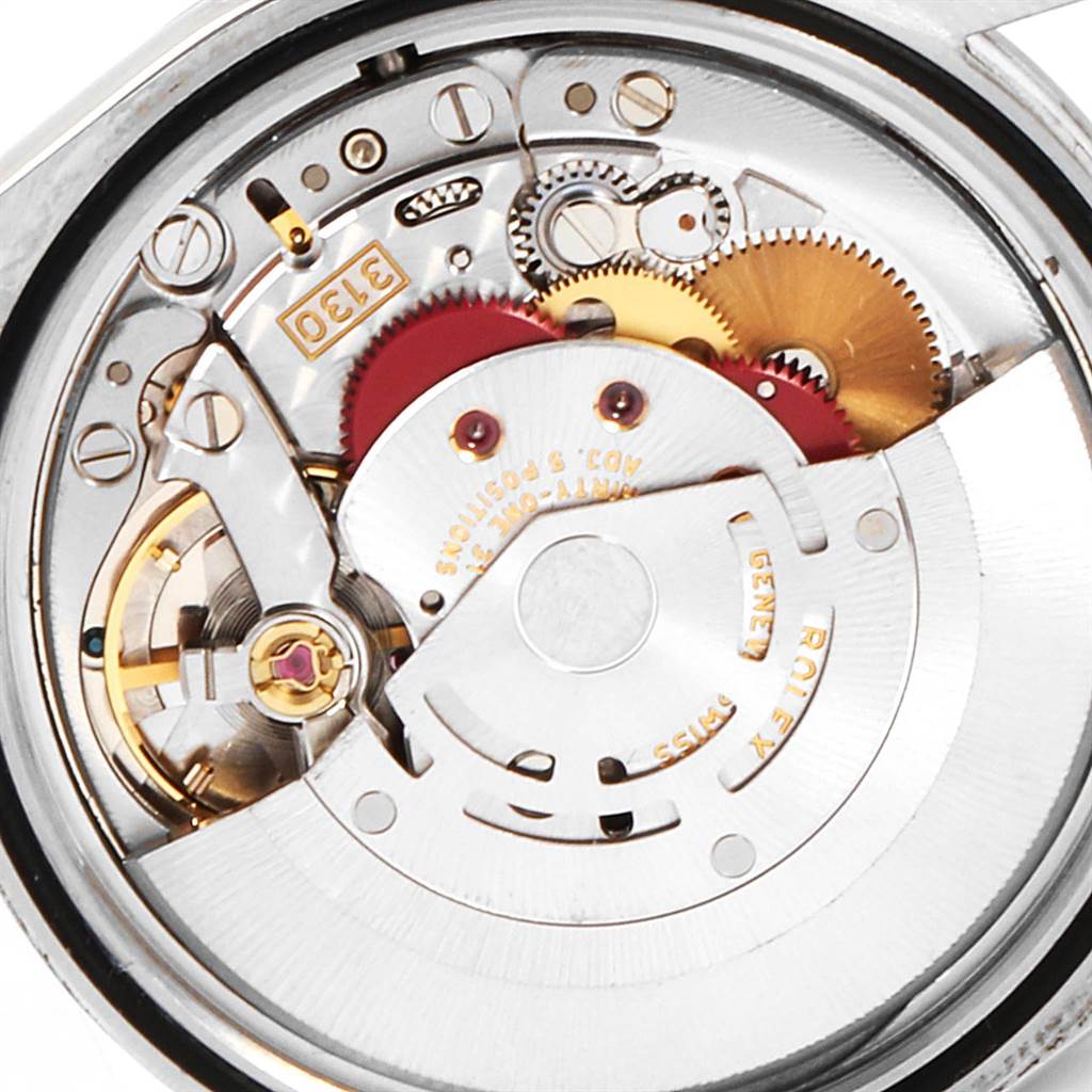 This is a close-up shot of the internal mechanism of a Rolex Explorer 114270 Men's Stainless Steel Black Dial 114270 Men's Stainless Steel Black Dial watch, showcasing its intricate gears and components.