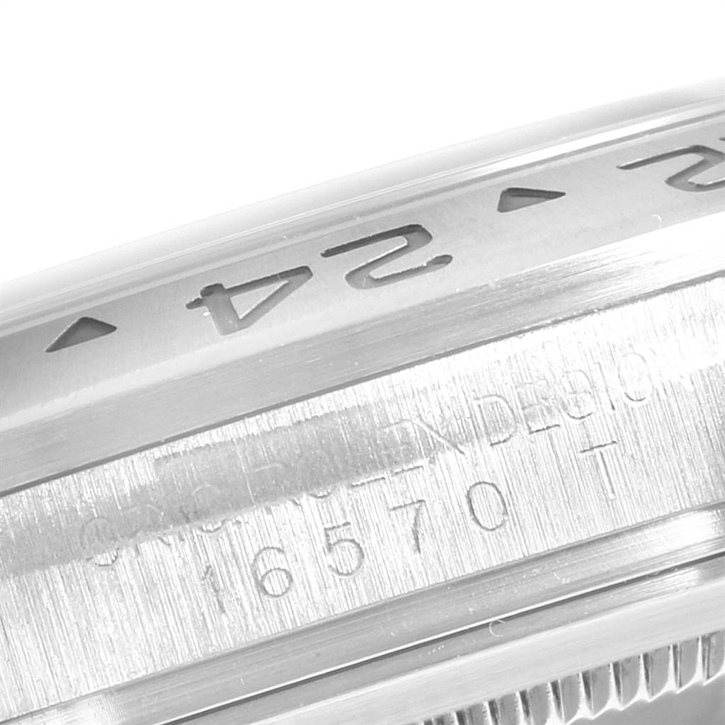The close-up image shows part of the bezel and engraved details on a Rolex Explorer 16570 Men's Stainless Steel White Dial 16570 Men's Stainless Steel White Dial watch.