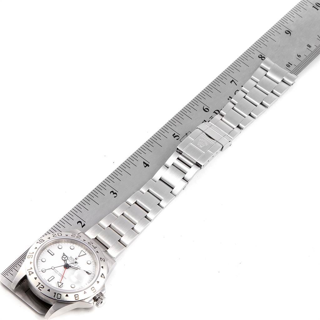 The image shows a top-down view of the entire Rolex Explorer 16570 Men's Stainless Steel White Dial 16570 Men's Stainless Steel White Dial watch with a measuring ruler beside it.