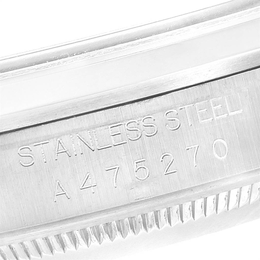 The image shows a close-up of the case back of a Rolex Explorer 14270 Men's Stainless Steel Black Dial 14270 Men's Stainless Steel Black Dial, specifically highlighting the stainless steel engraving and serial number.