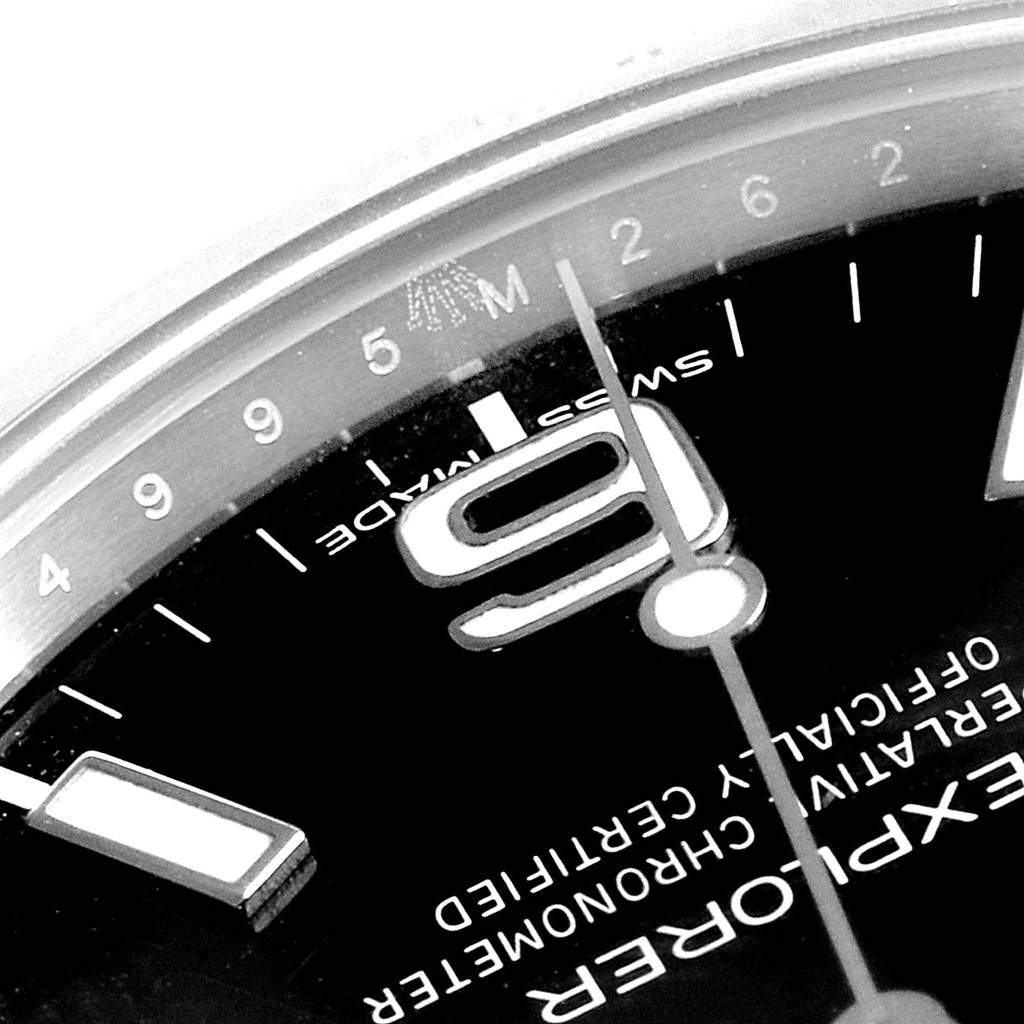 The image shows a close-up of the Rolex Explorer 214270 Men
s Stainless Steel Black Dial 214270 Men
s Stainless Steel Black Dial watch dial at an angle, highlighting the number 9, indices, and part of the minute hand.