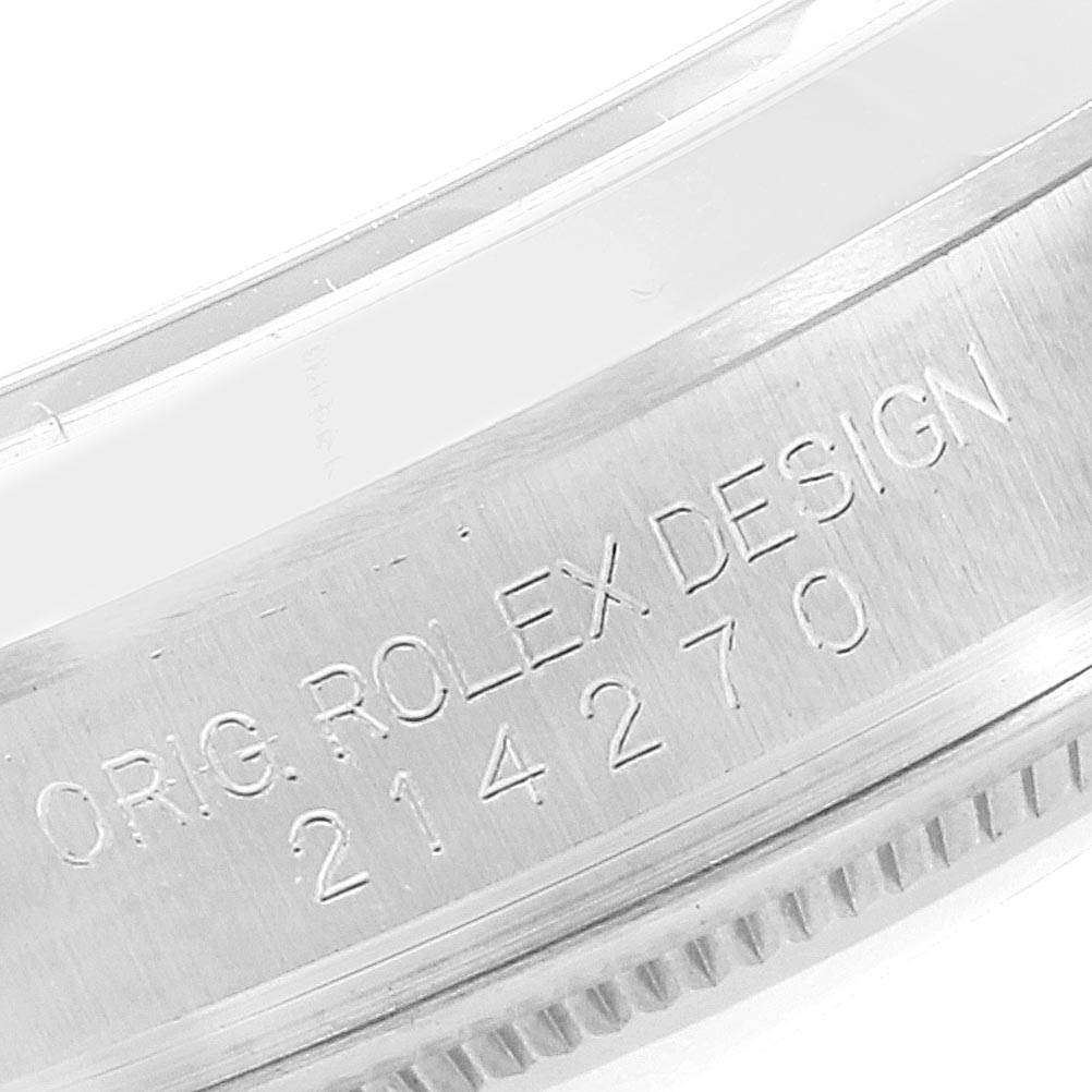 The image shows a close-up of the case band of the Rolex Explorer 214270 Men
s Stainless Steel Black Dial 214270 Men
s Stainless Steel Black Dial, displaying the engraved "ORIG. ROLEX DESIGN 214270".