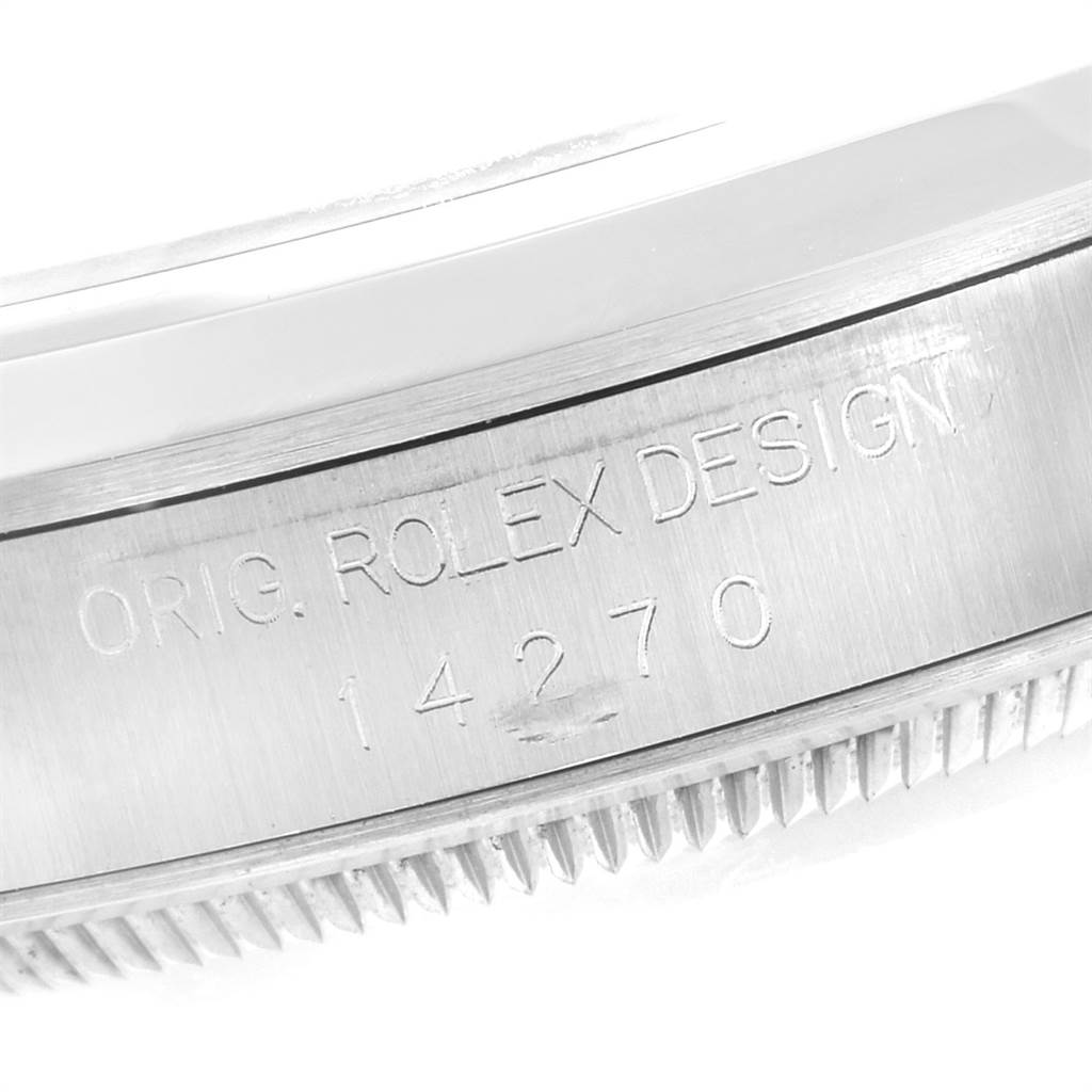 The image shows a close-up of the side of the case of a Rolex Explorer 14270 Men's Stainless Steel Black Dial 14270 Men's Stainless Steel Black Dial watch, highlighting the engraving "ORIG. ROLEX DESIGN" and model number 14270.