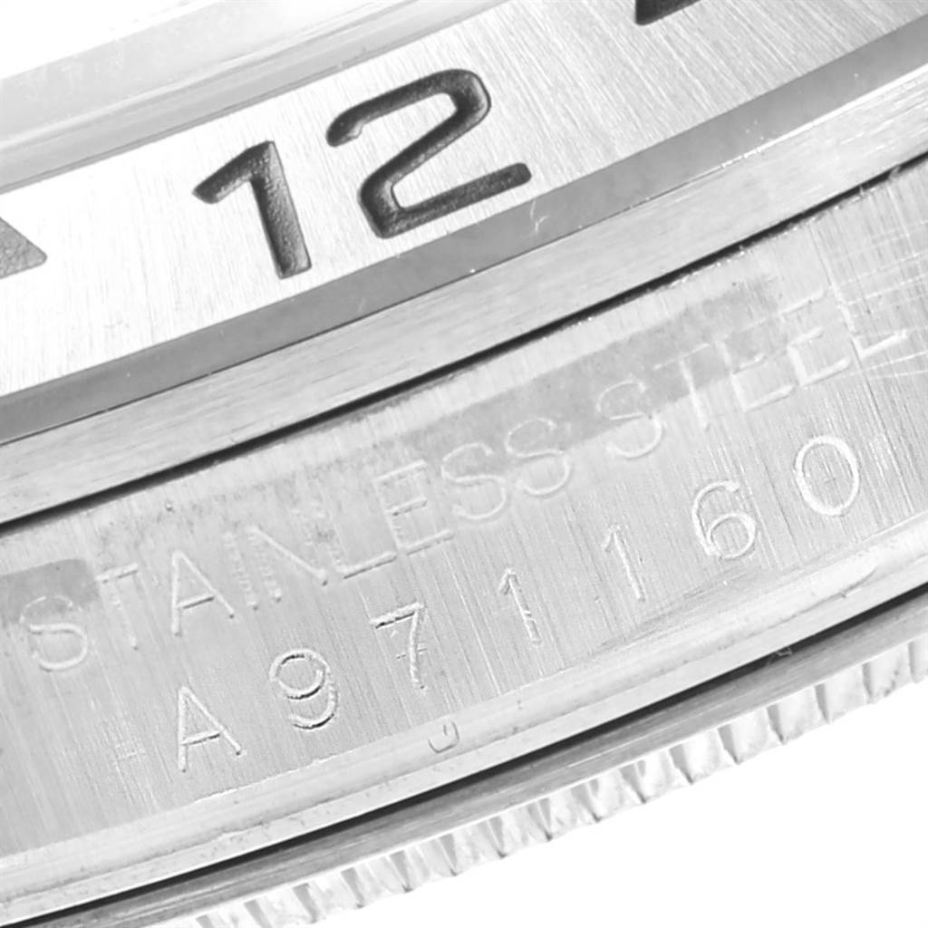 This image shows a close-up of the bezel and part of the case back of a Rolex Explorer 16570 Men's Stainless Steel White Dial 16570 Men's Stainless Steel White Dial watch.