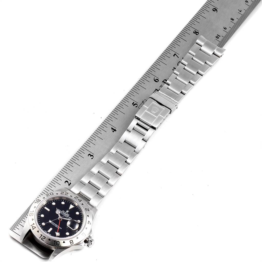 The image shows a Rolex Explorer 16570 Men's Stainless Steel Black Dial 16570 Men's Stainless Steel Black Dial watch, including the face, bezel, and metal bracelet, alongside a ruler for reference.