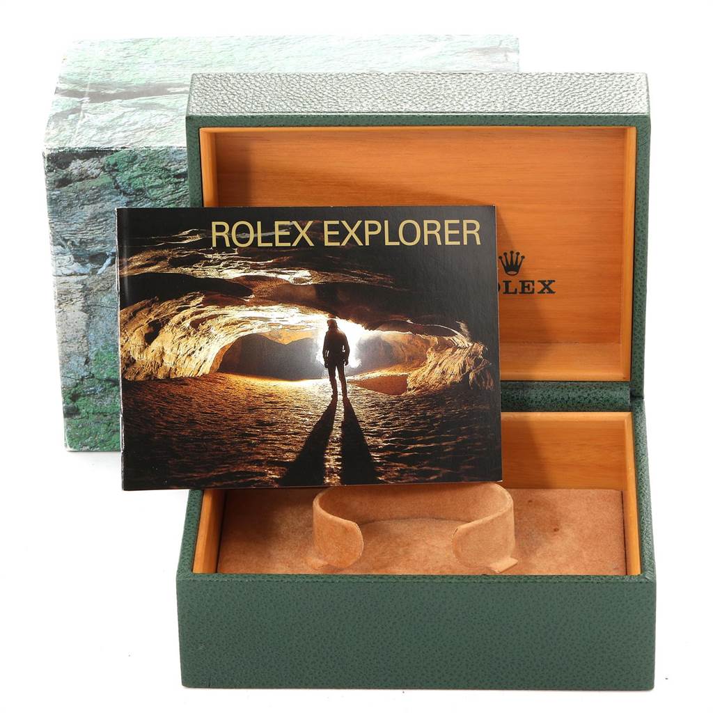 The image shows the open box and booklet for a Rolex Explorer 16570 Men's Stainless Steel Black Dial 16570 Men's Stainless Steel Black Dial model watch, viewed from the front.