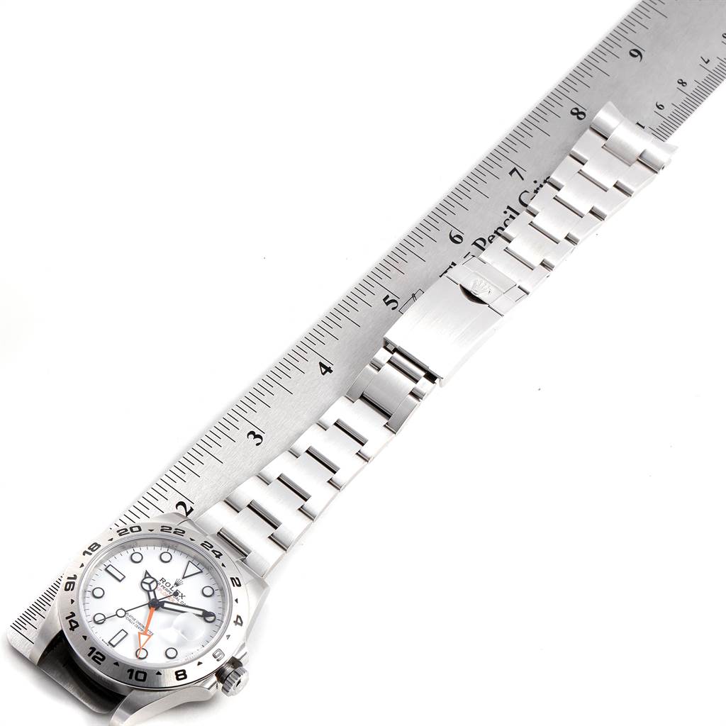 The image shows a top-down view of a Rolex Explorer 23690 Men's Stainless Steel White Dial 23690 Men's Stainless Steel White Dial watch, including its face and band, next to a ruler for measurement.