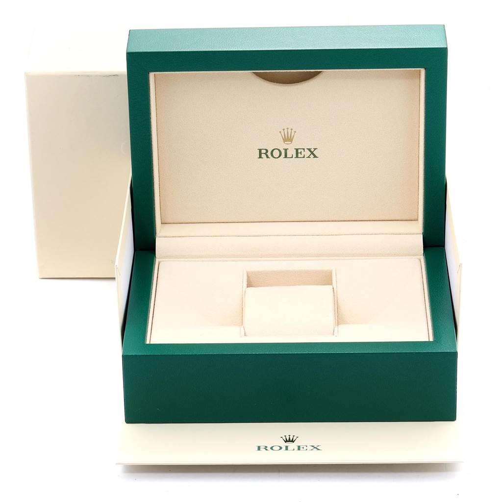 The image shows an open green and beige Rolex box for the Explorer model, with no watch inside.
