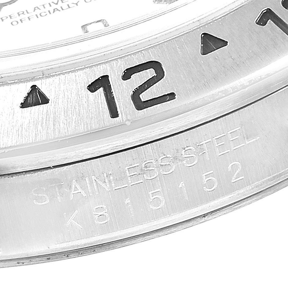 The image shows a close-up of the bezel and part of the case with engravings of a Rolex Explorer 16570 Men's Stainless Steel White Dial 16570 Men's Stainless Steel White Dial watch.