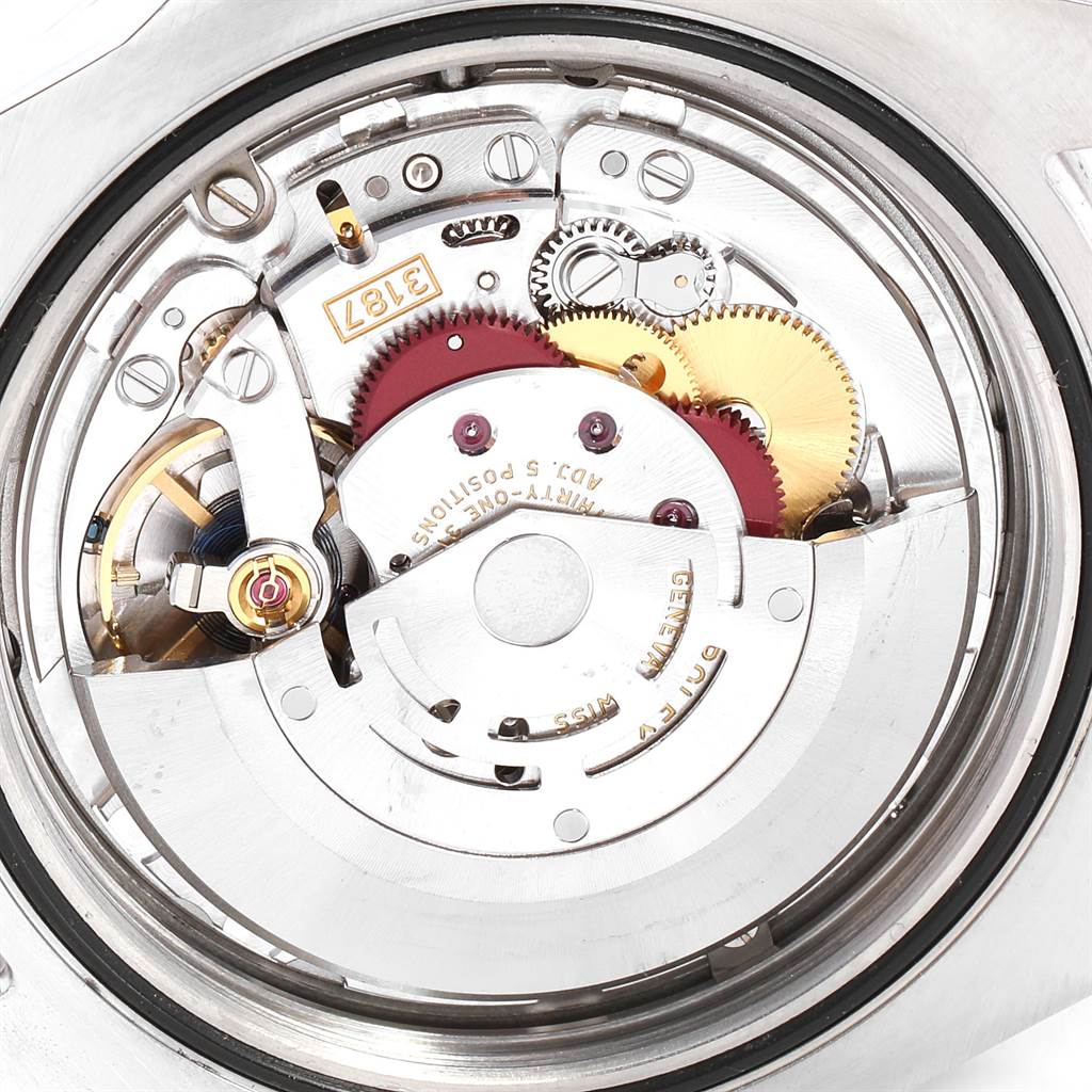 The image shows a close-up of the movement mechanism inside the Rolex Explorer 216570 Men's Stainless Steel Black Dial 216570 Men's Stainless Steel Black Dial watch, highlighting gears and intricate parts.